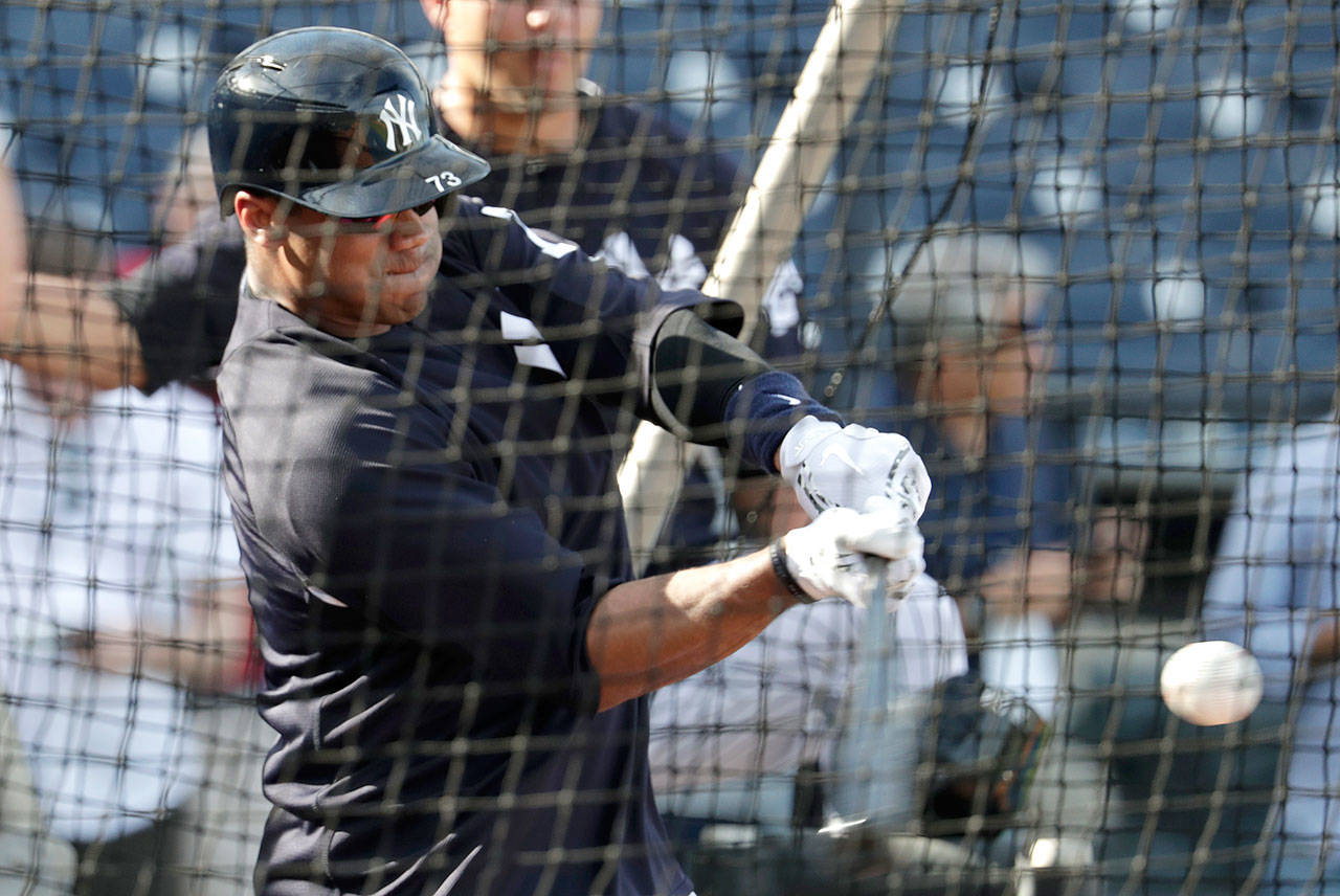 Seattle quarterback Russell Wilson takes batting practice with the New York Yankees on Monday in Tampa, Fla. (AP Photo/Lynne Sladky)