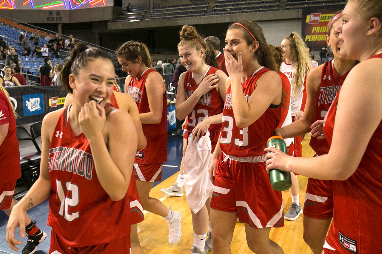 Stanwood players celebrate their win over Prairie in a 3A Hardwood Classic game on Feb. 28, 2018, at the Tacoma Dome. (Kevin Clark / The Herald)