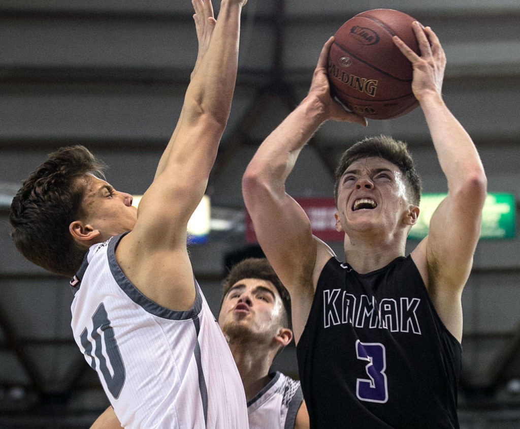 Kamiak’s Carson Tuttle attempts a shot over Union’s Zach Reznick during the 4A Hardwood Classic on Feb. 28, 2018, at the Tacoma Dome. (Kevin Clark / The Herald)
