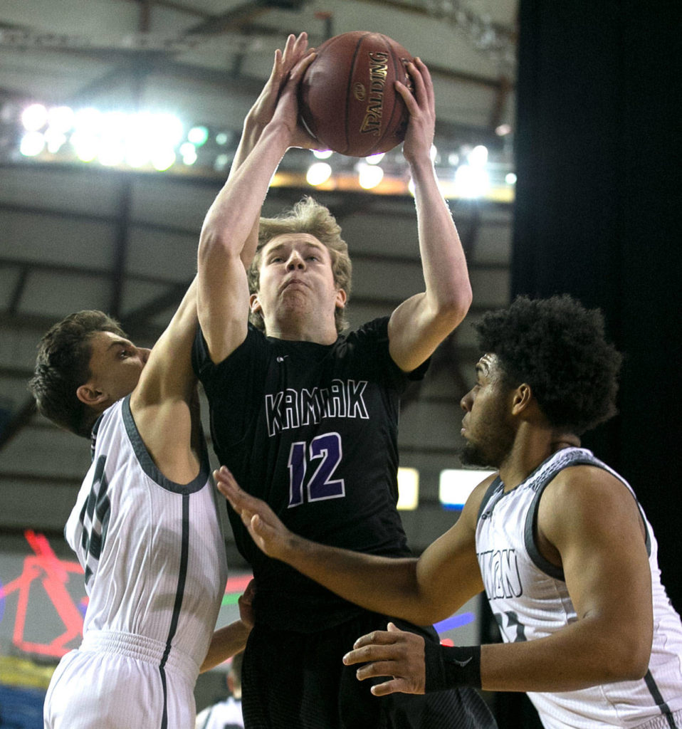 Kamiak’s Conner Fitzpatrick (center) attempts a shot with Union’s Zach Reznick (left) and Union’s Alishawuan Taylor (right) defending during the 4A Hardwood Classic on Feb. 28, 2018, at the Tacoma Dome. (Kevin Clark / The Herald)
