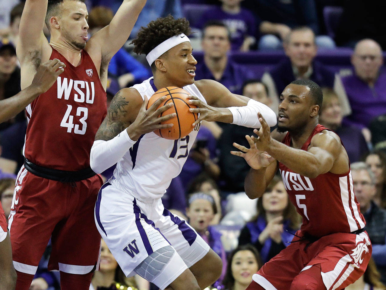 Washington forward Hameir Wright (13) keeps the ball away from Washington State guard Milan Acquaah (right) and forward Drick Bernstine (43) on Jan. 28, 2018, in Seattle. Washington won 80-62. (AP Photo/Ted S. Warren)