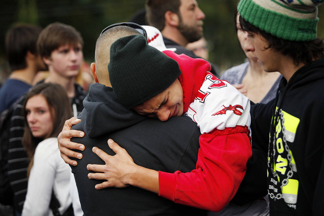 Keith Pablo reunites with friends and family outside of Shoultes Christian Assembly just northwest of Marysville Pilchuck High School in Marysville on Friday afternoon. Students were evacuated by bus to the location after a shooting at the school Friday morning, Oct. 24, 2014. (Genna Martin / The Herald)