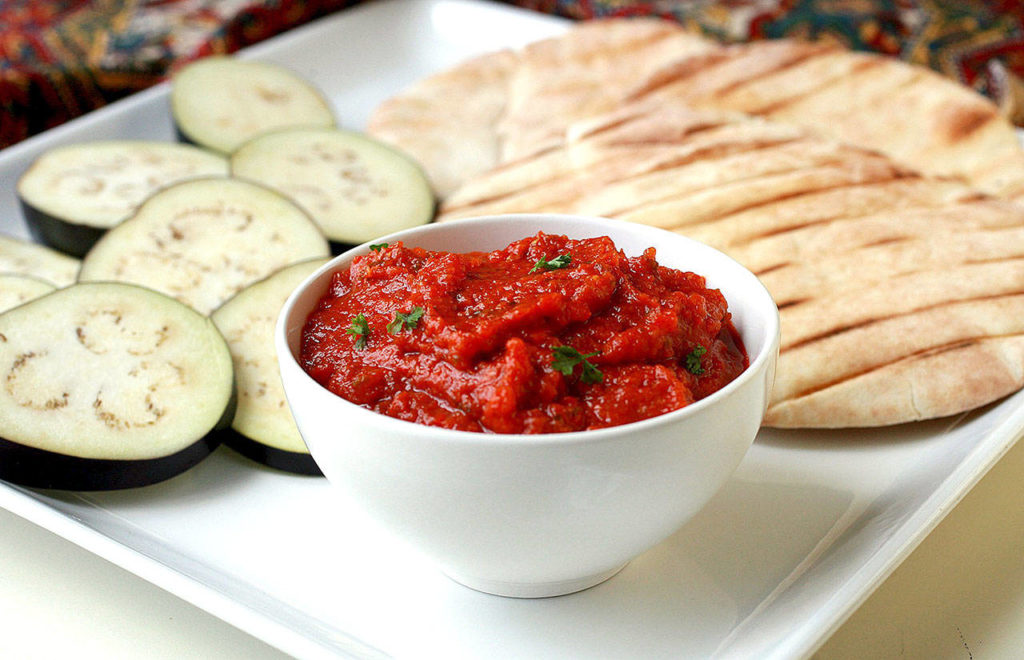 This pepper spread made with eggplant can be served on pita (pictured) or a baguette. (Hillary Levin/St. Louis Post-Dispatch)
