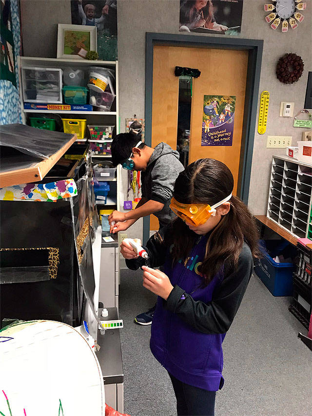 Fourth-grade students Anthony Gonzalez-Marroquin and Khailiyah Mackeyin test water quality in teacher Nikko Linn’s classroom at Silver Firs Elementary School in Everett. (Contributed photo)