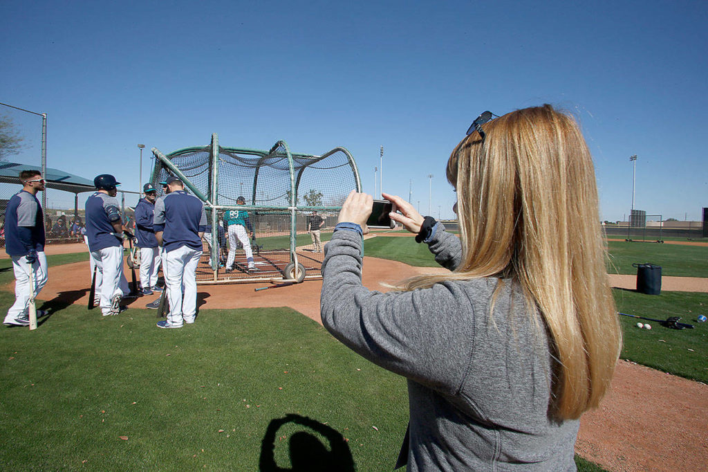 Drayer takes photos and video with her phone of the Mariners during spring training. (Ben VanHouten/ Seattle Mariners)
