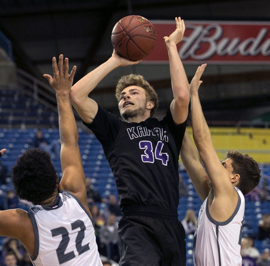Kamiak’s Daniel Sharpe attempts a shot over Union’s Alishawuan Taylor (left) and Union’s Zach Reznick during the WIAA state basketball tournament Wednesday at the Tacoma Dome in Tacoma on February 28, 2018. (Kevin Clark / The Daily Herald)
