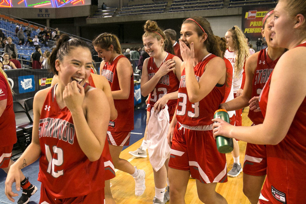 Stanwood celebrates their win over Prairie to advance in the WIAA state basketball tournament Wednesday at the Tacoma Dome in Tacoma on February 28, 2018. (Kevin Clark / The Daily Herald)
