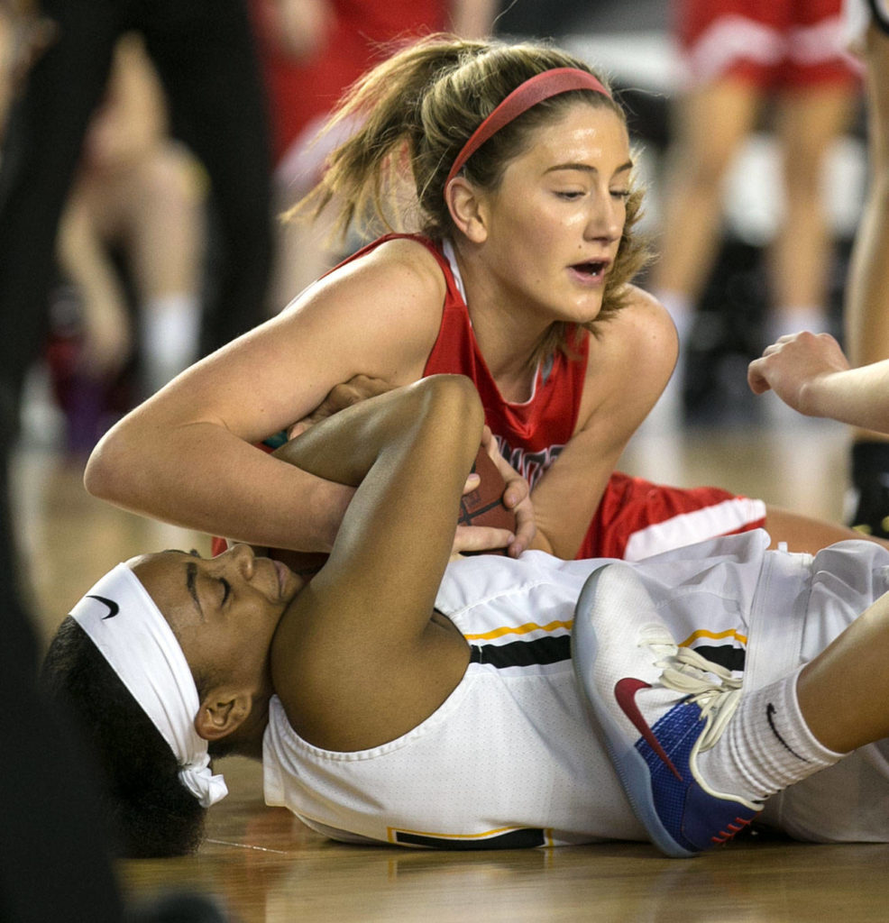 Stanwood’s Jillian Heichel (top) and Lincoln’s Azallee Johnson struggle for a loose ball during the WIAA state basketball tournament Wednesday at the Tacoma Dome in Tacoma on March 1, 2018. (Kevin Clark / The Daily Herald)
