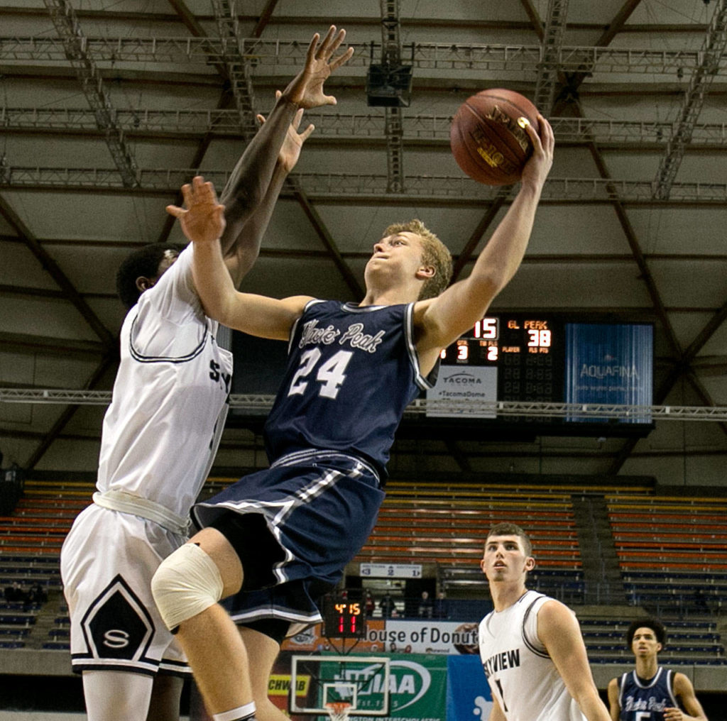 Glacier Peak’s Evan Mannes attempts a shot with Skyview’s Samaad Hector during the WIAA state basketball tournament Wednesday at the Tacoma Dome in Tacoma on February 28, 2018. (Kevin Clark / The Daily Herald)
