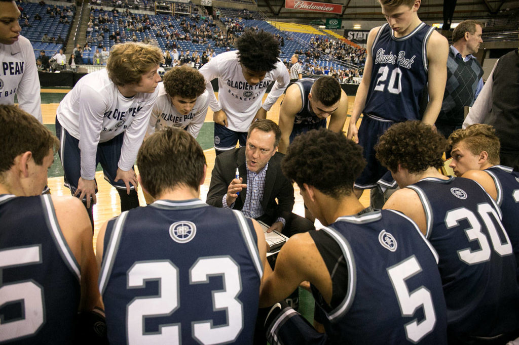 Glacier Peak’s head coach, Brian Hunter, makes plans during a timeout during the WIAA state basketball tournament Wednesday at the Tacoma Dome in Tacoma on February 28, 2018. (Kevin Clark / The Daily Herald)
