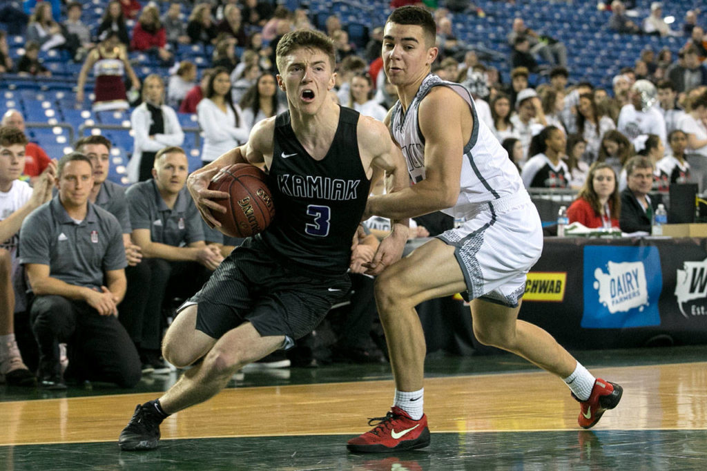 Kamiak’s Carson Tuttle drives the baseline with Union’s Coby Weatherspoon defending during the WIAA state basketball tournament Wednesday at the Tacoma Dome in Tacoma on February 28, 2018. (Kevin Clark / The Daily Herald)