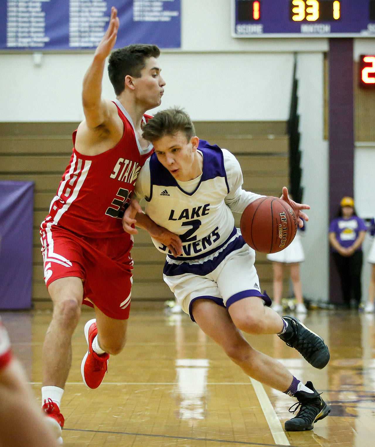 Ryder Kavanagh drives against Stanwood’s Nate Kummer during a non-conference basketball game on Dec. 5, 2017, at Lake Stevens High School. Kavanagh earned first-team Wesco 4A honors and Kummer was named to the Wesco 3A/2A second team. (Ian Terry / The Herald)