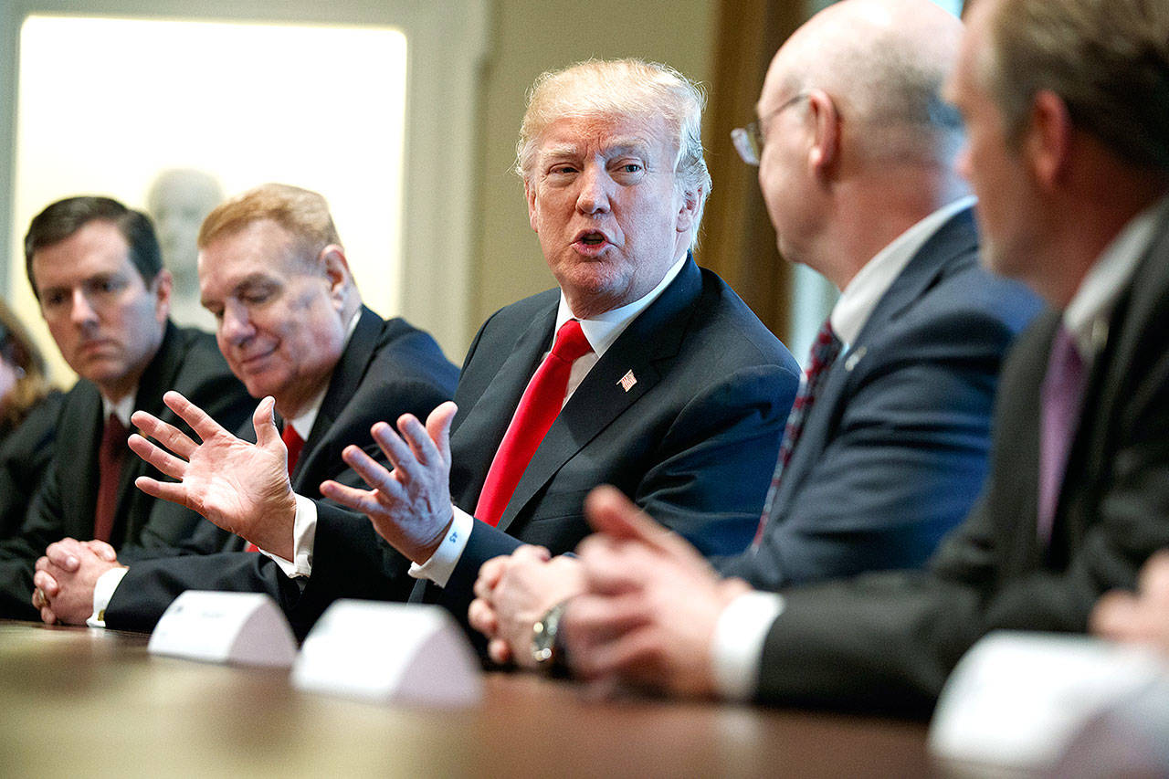 President Donald Trump speaks during a meeting with steel and aluminum executives in the Cabinet Room of the White House on Thursday in Washington. From left: Roger Newport of AK Steel, John Ferriola of Nucor, Trump, Dave Burritt of U.S. Steel Corporation and Tim Timkin of Timken Steel. (AP Photo/Evan Vucci)