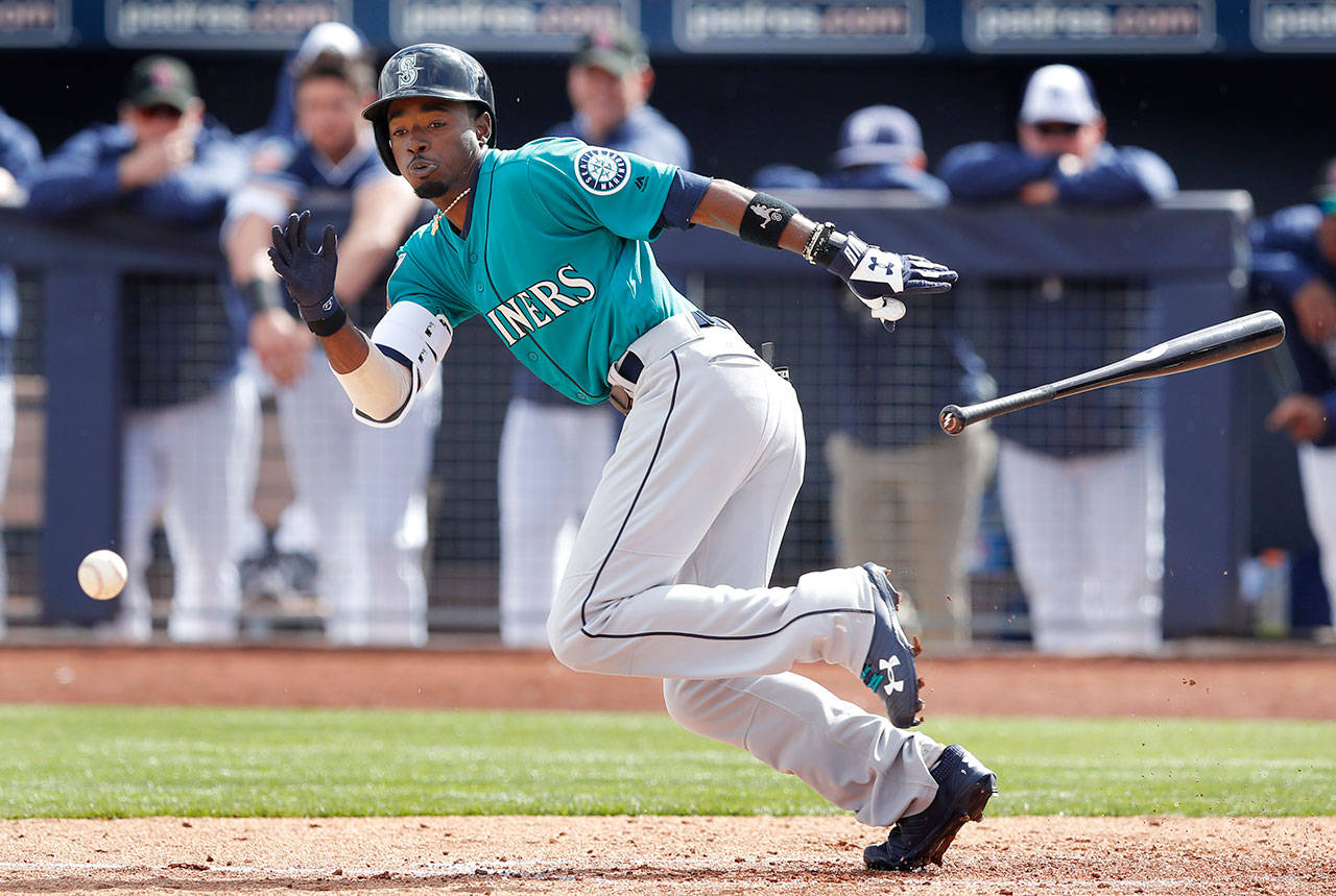 The Mariners’ Dee Gordon bunts during the second inning of a spring game against the Padres on Feb. 23, 2018, in Peoria, Ariz. (AP Photo/Charlie Neibergall)