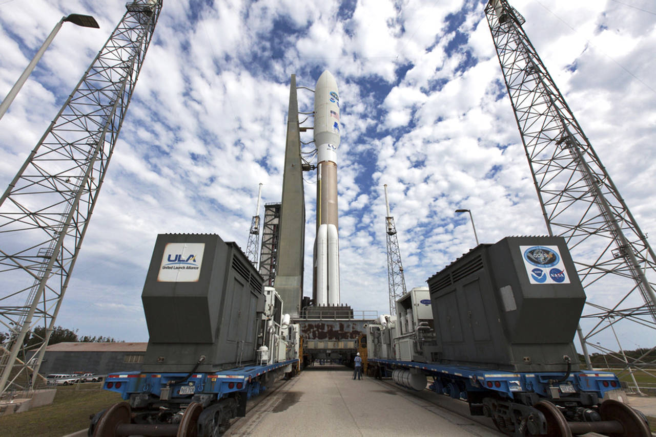 A United Launch Alliance Atlas V rocket, waiting for liftoff on Thursday, is rolled to Space Launch Complex 41 at Cape Canaveral Air Force Station in Florida. (Ben Smegelsky/NASA via AP)