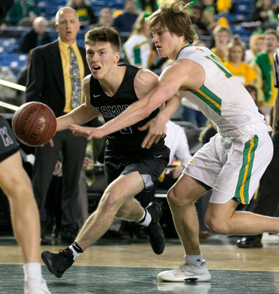 Kamiak’s Carson Tuttle drives with Richland’s Cody Sanderson defending during a 4A boys Hardwood Classic game on March 1, 2018, at the Tacoma Dome. (Kevin Clark / The Herald)
