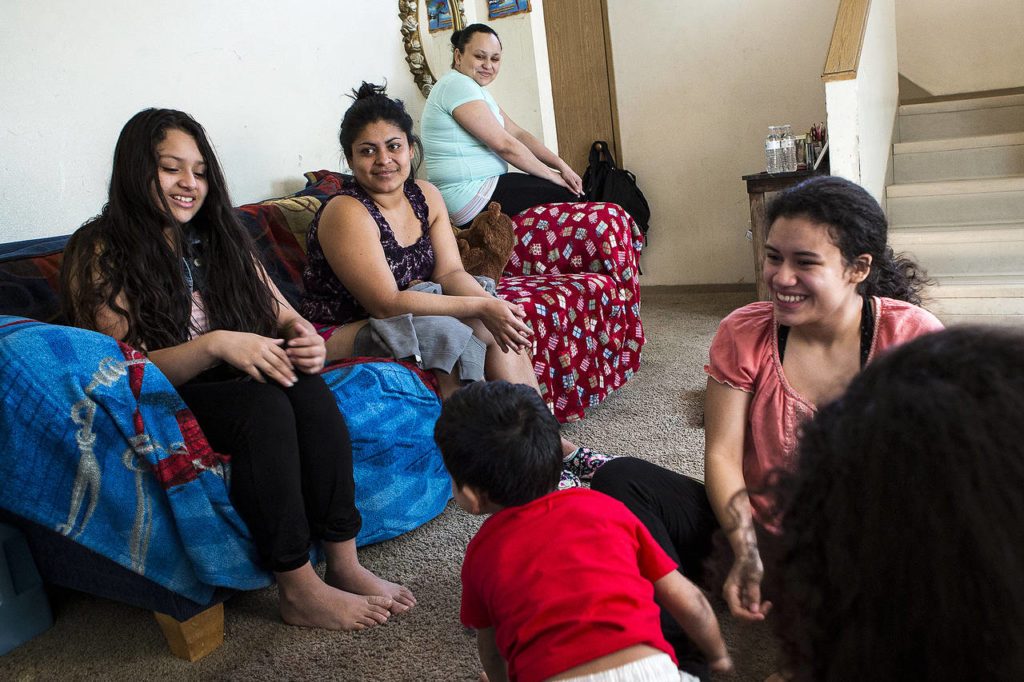 The Alvarado-Pineda family spends time together at home in Marysville on March 3. Caught under tightening immigration policies set forth by President Trump, Bernarda Pineda (top), a single mother of three, was notified by U.S. authorities Feb. 20 that she was being deported to Honduras, a country she fled from 12 years ago. (Ian Terry / The Herald)
