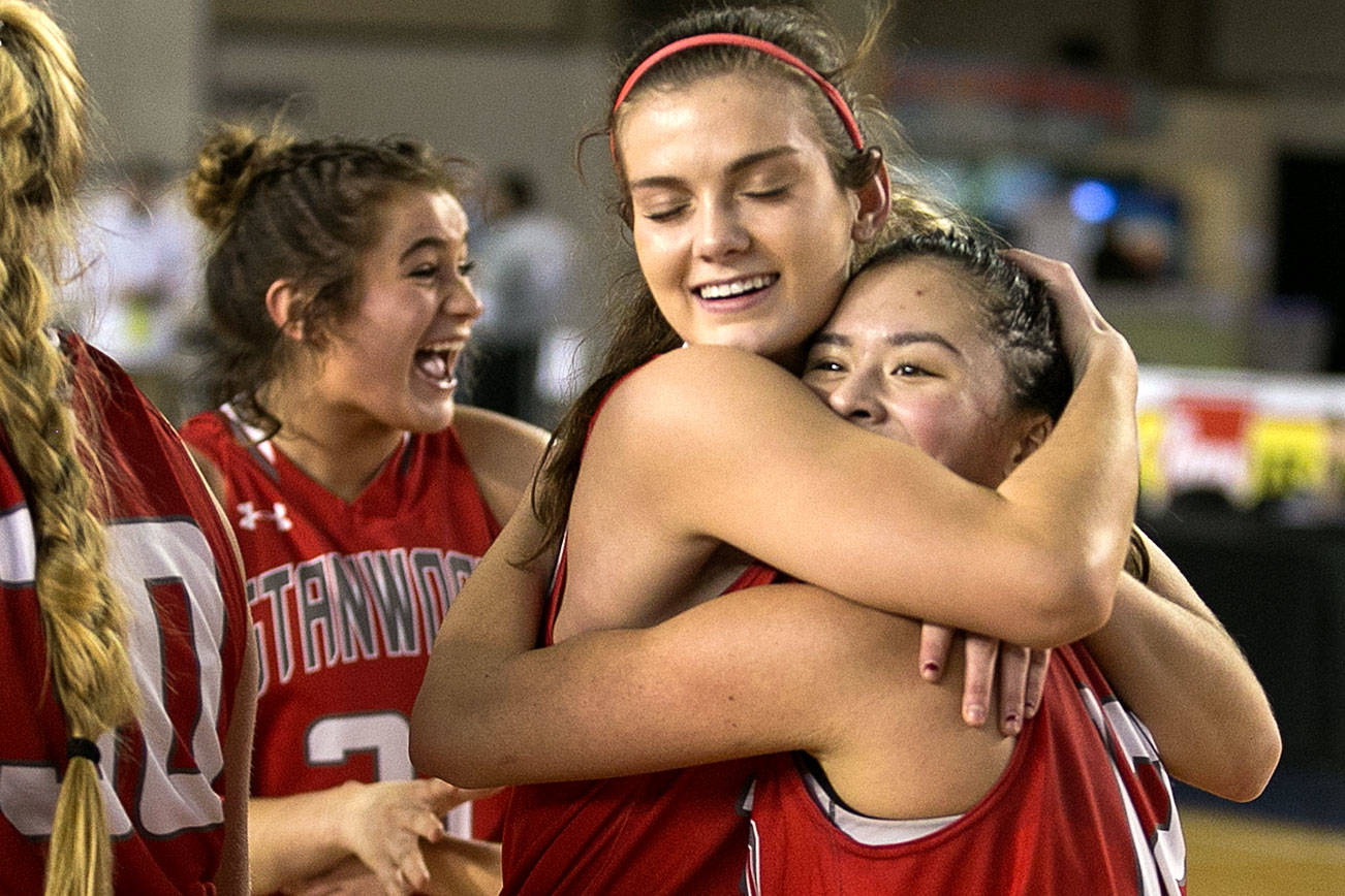 Stanwood celebrates their win over Lincoln to advance to the semifinals in the WIAA state basketball tournament Wednesday at the Tacoma Dome in Tacoma on March 1, 2018. (Kevin Clark / The Daily Herald)
