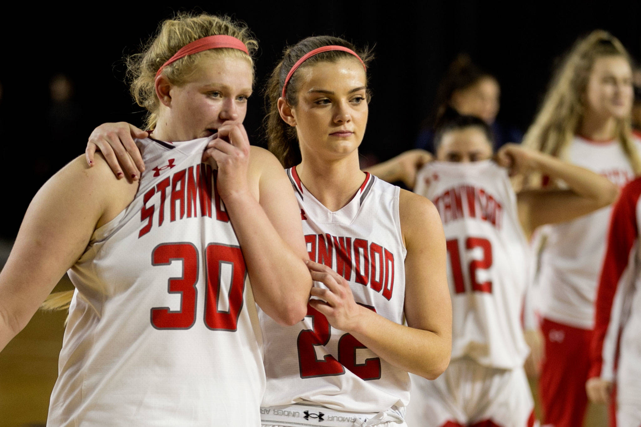 Kaitlin Larson (left) is comforted by Ashley Alter after losing to Garfield for the semifinals of the 3A Hardwood Classic on March 2, 2018, at the Tacoma Dome. (Kevin Clark / The Herald)