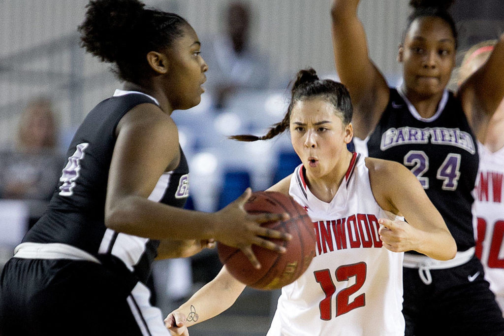 Stanwood’s Kayla Frazier defends Garfield’s Cari Davis during the semifinals of the 3A Hardwood Classic on March 2, 2018, at the Tacoma Dome. (Kevin Clark / The Herald)
