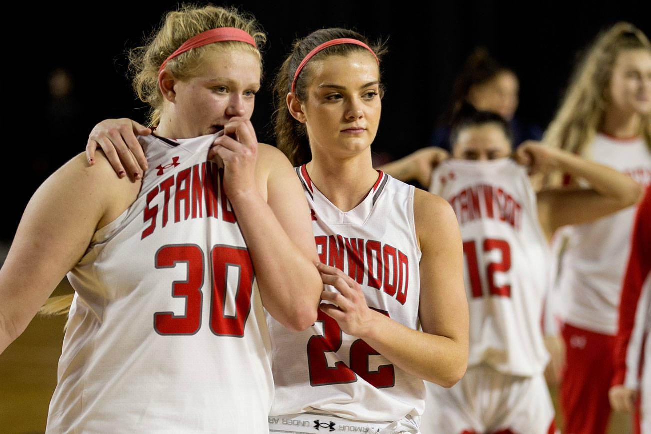 Kaitlin Larson (left) is comforted by Ashley Alter after loosing to Garfield for the semifinals of the 3A Hardwood Classic Friday night at the Tacoma Dome in Tacoma on March 2, 2018. (Kevin Clark / The Daily Herald)