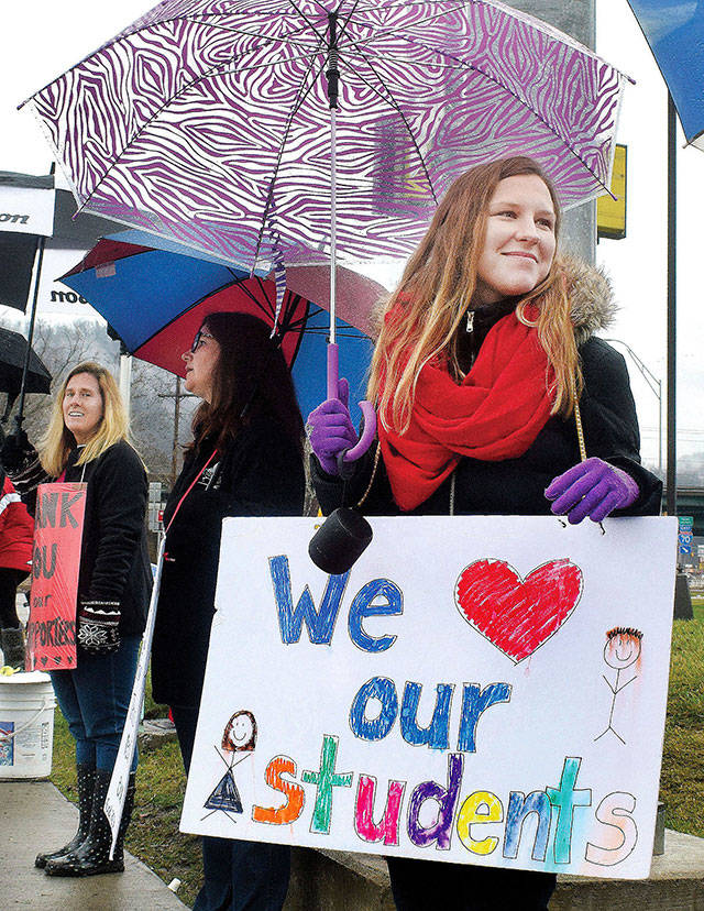 Stefanie Cirilli, a special education teacher at Elm Grove Elementary stands with nearly a dozen other teachers along National Road in Wheeling, West Virginia, on Thursday as part of the on-going statewide teachers walkout. (Scott McCloskey/The Intelligencer)