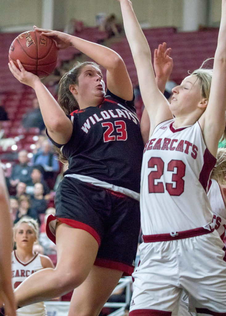 Archbishop Murphy’s Natalie Hayward (23) scores over W.F. West’s Erika Brumfield (23) in the 2A girls Hardwood Classic championship game on March 3, 2018, at the Yakima Valley SunDome. W.F. West defeated Archbishop Murphy 64-52. (TJ Mullinax / For The Herald)
