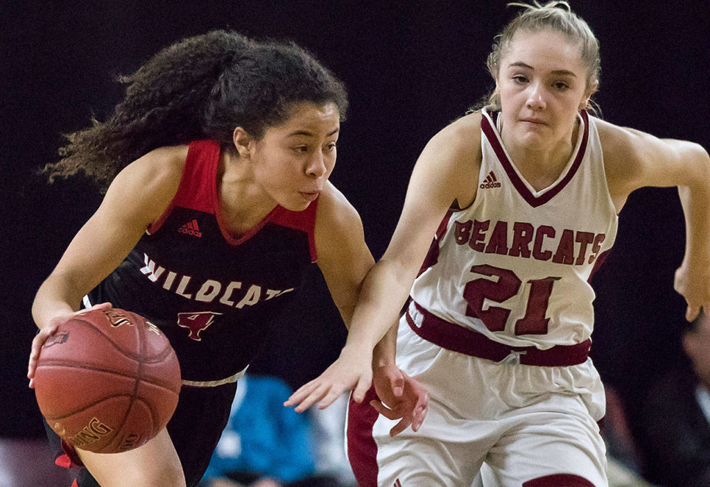 Archbishop Murphy’s Maddie Hill (4) drives through W.F. West’s Courtney Bennett (21) in the 2A girls Hardwood Classic championship game on March 3, 2018, at the Yakima Valley SunDome. W.F. West defeated Archbishop Murphy 64-52. (TJ Mullinax / For The Herald)
