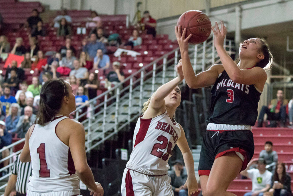 Archbishop Murphy’s Maddie Hill (3) attempts a lay-up around W.F. West’s Lauren Tornow (25) in the 2A girls Hardwood Classic championship game on March 3, 2018, at the Yakima Valley SunDome. W.F. West defeated Archbishop Murphy 64-52. (TJ Mullinax / For The Herald)
