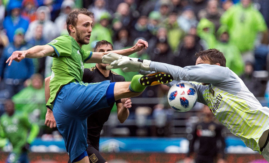 Sounders’ midfielder Magnus Wolff Eikrem attempts a shot with Los Angeles’ goalkeeper Tyler Miller diving in on the Xbox Pitch at CenturyLink Field Sunday afternoon in Seattle on March 4, 2018. Los Angeles FC won 1-0. (Kevin Clark / The Daily Herald)
