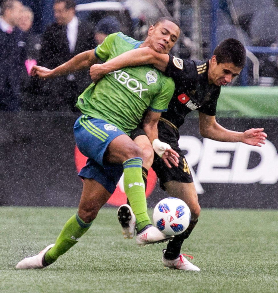 Sounders’ midfielder Henry Wingo (left) vies for the ball with Los Angeles’ defender Joo Moutinho on the Xbox Pitch at CenturyLink Field Sunday afternoon in Seattle on March 4, 2018. Los Angeles FC won 1-0. (Kevin Clark / The Daily Herald)
