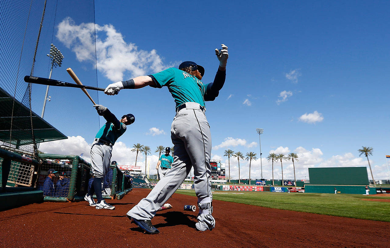 Seattle outfielder Ben Gamel (right) takes practice swings as he waits to bat prior to a Cactus League game against the Cleveland Indians on Feb. 28, 2018, in Goodyear, Arizona. (AP Photo/Ross D. Franklin)