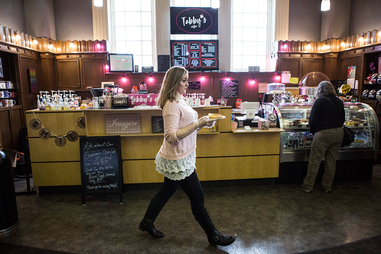 Tabitha Tarter takes a grilled cheese sandwich to a customer. (Andy Bronson / The Herald)