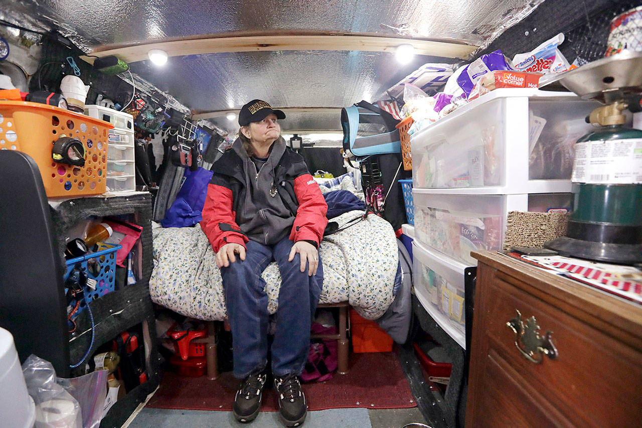 Tamara Bancroft sits inside her van on Monday, where she lives with her partner among the two-dozen or so vehicles housing homeless single women in a church parking lot in Kirkland. (AP Photo/Elaine Thompson)