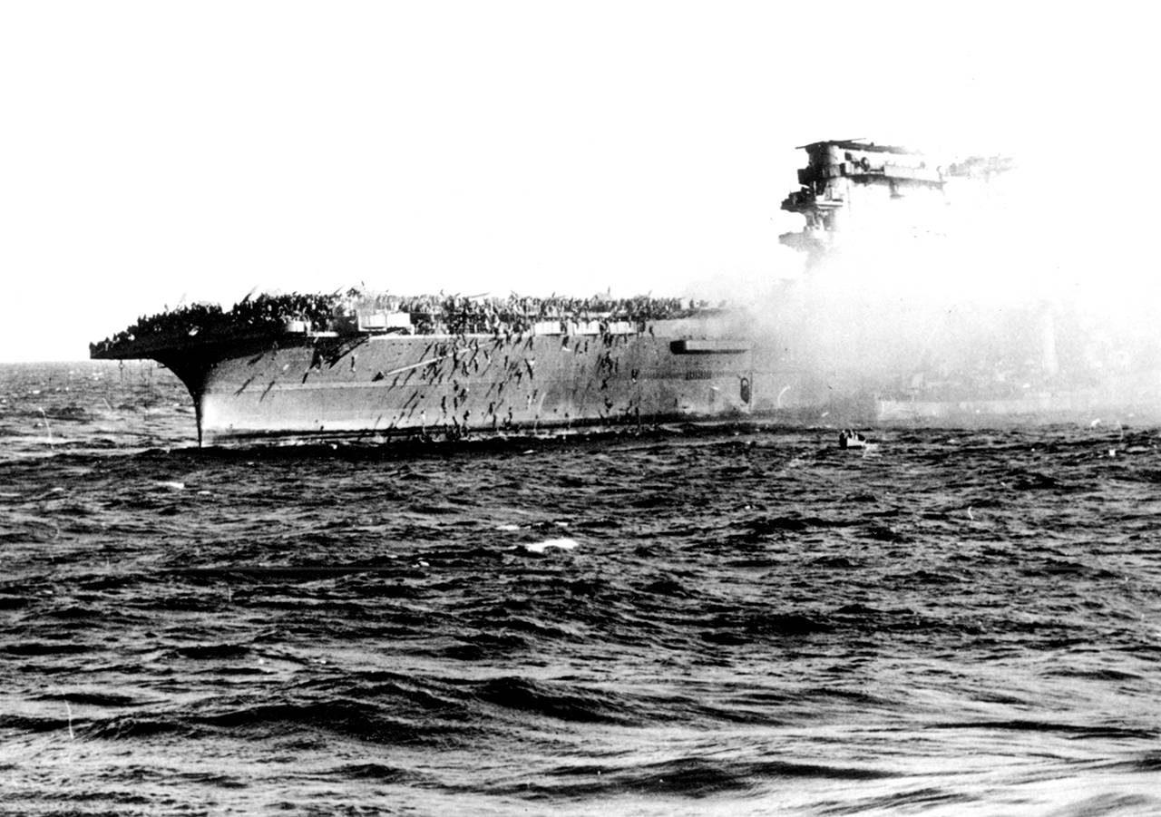 In this 1942 file photo, the crew abandons the USS Lexington after the decks of the aircraft carrier sunk in the Battle of the Coral Sea during World War II. A piece of prized World War II U.S. naval history, the wreckage of the aircraft carrier USS Lexington, which was sunk by the Japanese in a crucial sea battle, was discovered by an expedition funded by Microsoft co-founder Paul Allen on March 4. (U.S. Navy via AP)