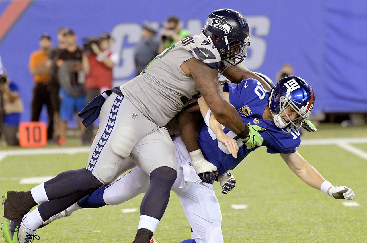 The Seahawks’ Sheldon Richardson (left) tackles Giants quarterback Eli Manning during the second half of a game Oct. 22, 2017, in East Rutherford, N.J. (AP Photo/Bill Kostroun)