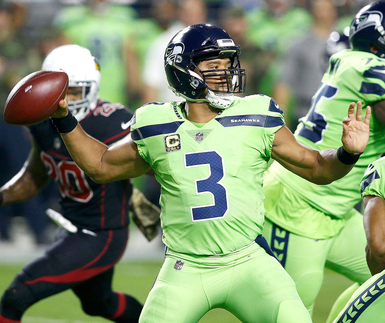 Seattle Seahawks quarterback Russell Wilson (3) throws a pass against the Arizona Cardinals during a game in November. Wilson is going to host an ESPN special called “QB2QB.” (AP Photo/Ross D. Franklin)