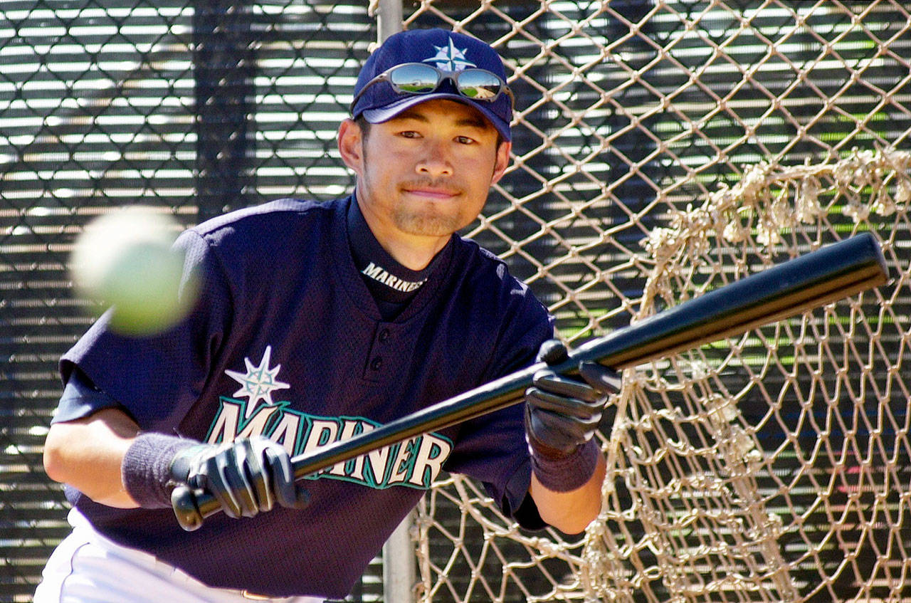 Ichiro Suzuki follows the path of the ball during a spring-training workout in Peoria, Arizona, in 2001. (AP Photo/Elaine Thompson)