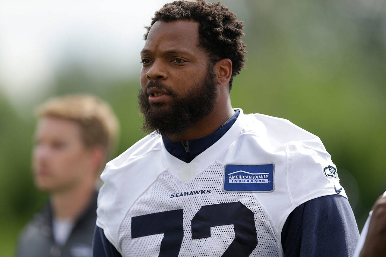 In this June 13, 2017, file photo, Seattle Seahawks defensive end Michael Bennett walks off the field following a practice in Renton. The Associated Press reported Wednesday that Bennett has been traded to the Phialdelphia Eagles. (AP Photo/Ted S. Warren, File)