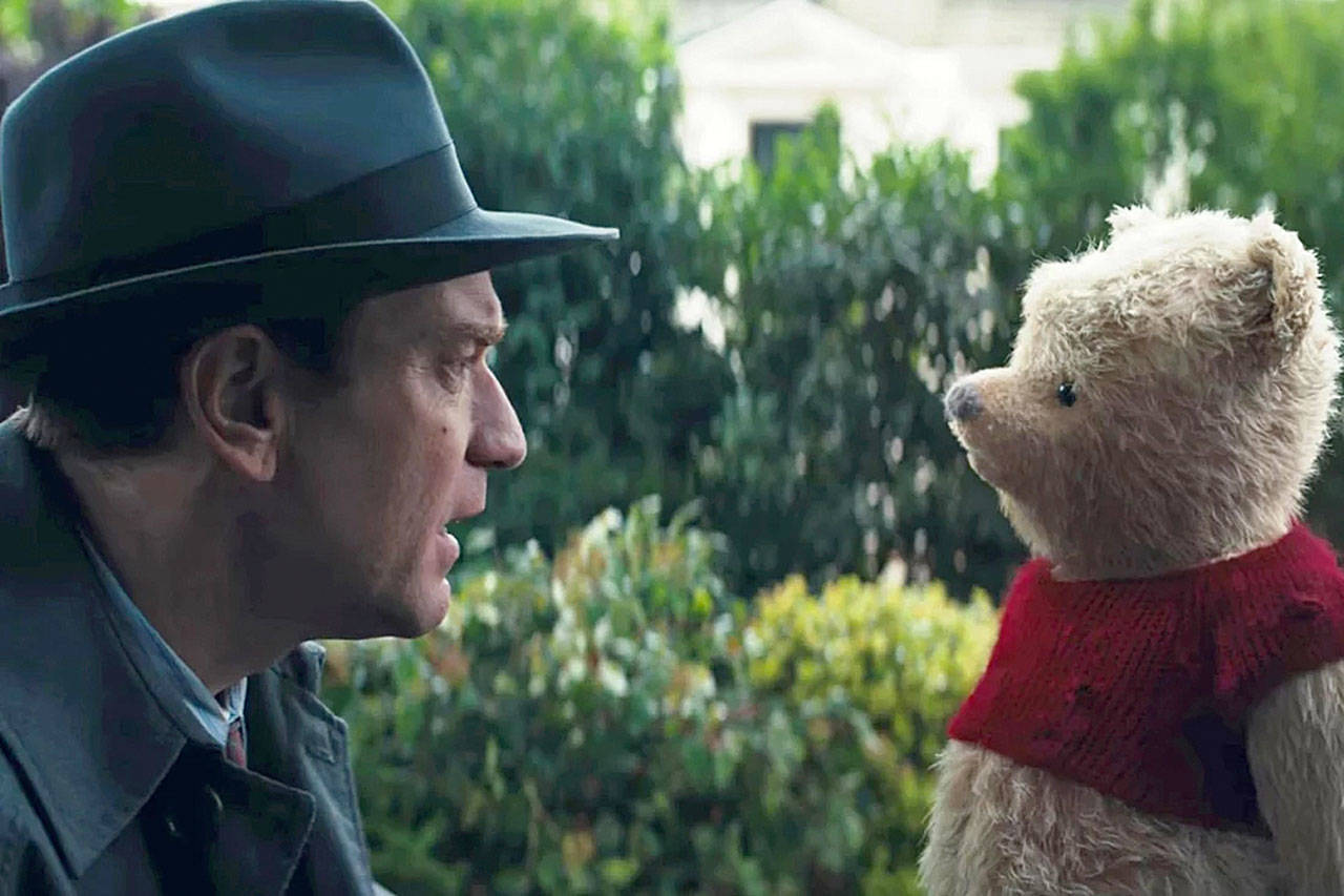 A grown up Christopher Robin, portrayed by Ewan McGregor, reunites with Winnie the Pooh in “Christopher Robin.” (Disney)