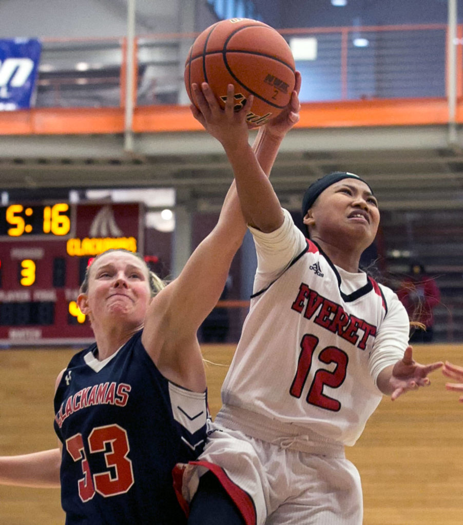 Clackamas’ Ricki Mock (left) blocks a shot attempt by Everett’s Aloha Salem during an NWAC Tournament game on March 8, 2018, at Everett Community College. (Kevin Clark / The Herald)
