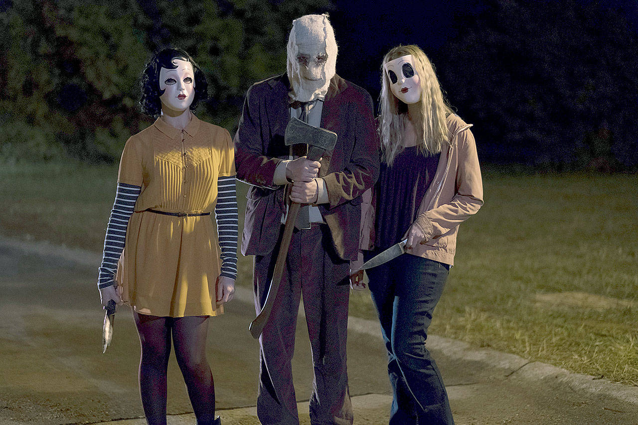 Pinup Girl, Man in the Mask and Dollface are back 10 years later to terrorize a family in “The Strangers: Prey at Night.” (Brian Douglas, Aviron Pictures)