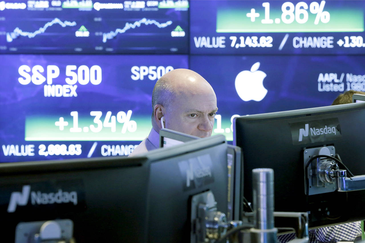 A Nasdaq employee works at his computer in New York. (AP Photo/Richard Drew, File)