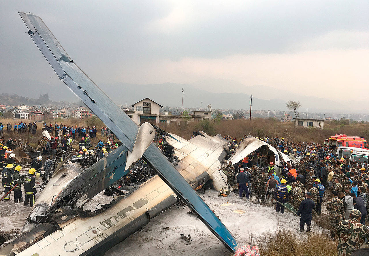 The passenger plane from Bangladesh that crashed at the airport in Kathmandu, Nepal, on Monday. (AP Photo/Niranjan Shreshta)