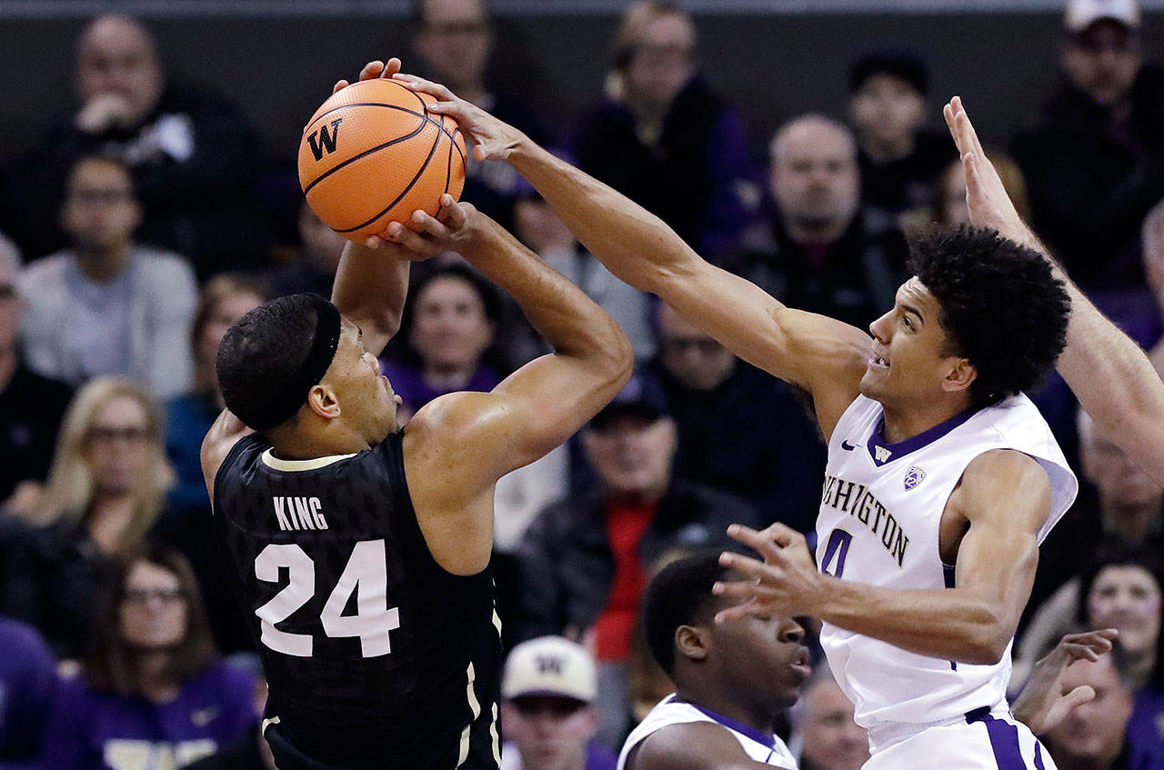 Washington’s Matisse Thybulle (right) blocks a shot by Colorado’s George King in the first half of a game Feb. 17, 2018, in Seattle. (AP Photo/Elaine Thompson)
