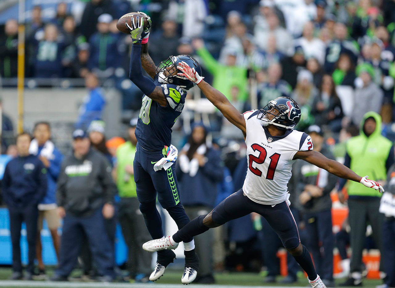 Seahawks wide receiver Paul Richardson (10) makes a catch above Texans strong safety Marcus Gilchrist (21) in the second half of a game Oct. 29, 2017, in Seattle. (AP Photo/Stephen Brashear)