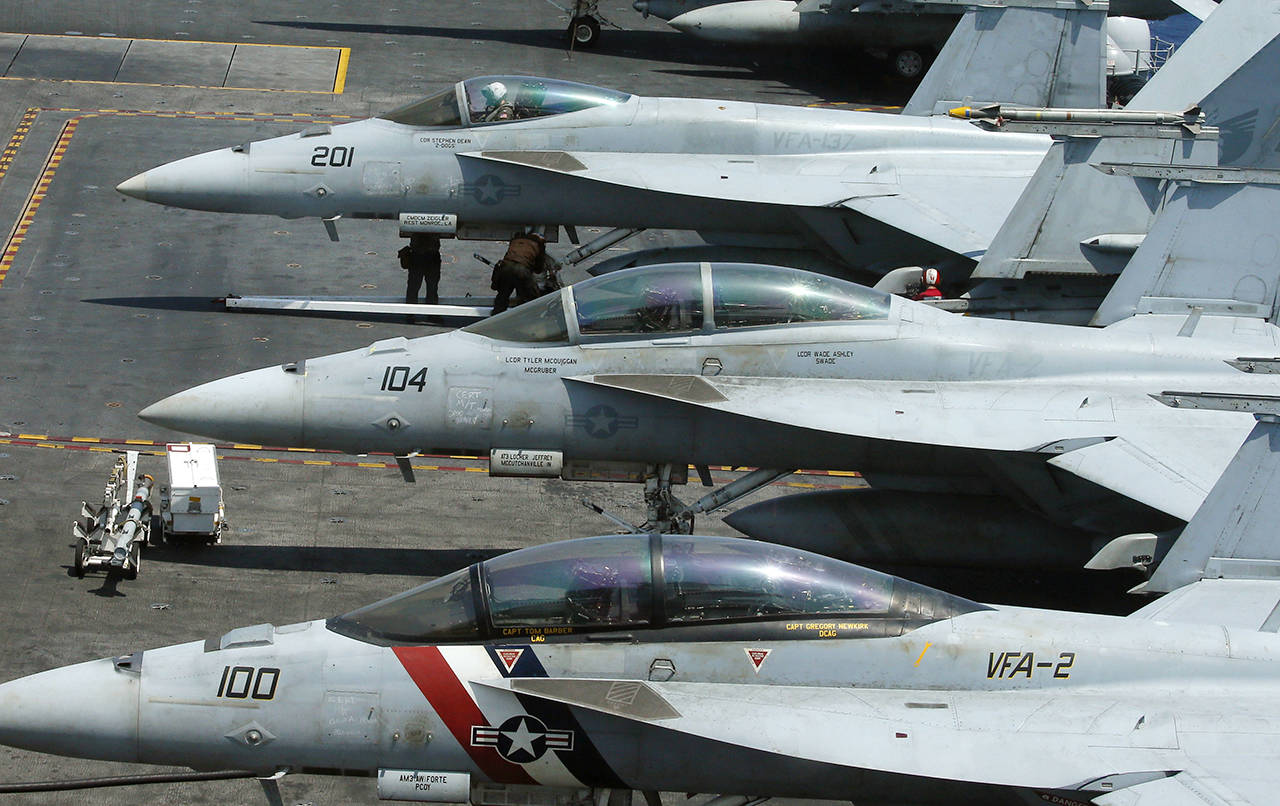 A row of F18 fighter jets are shown on the deck of the U.S. Navy aircraft carrier USS Carl Vinson (CVN 70) off the disputed South China Sea in March 2017. Navy officials say a fighter jet crashed off the coast of Key West, Florida. (AP Photo/Bullit Marquez, file)