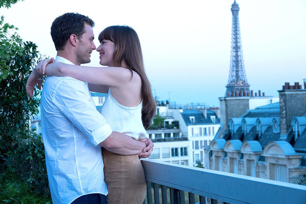 Jamie Dornan, left, and Dakota Johnson in “Fifty Shades Freed.” His character considers leaving hers because of her pregnancy. (Doane Gregory/ Universal Pictures)
