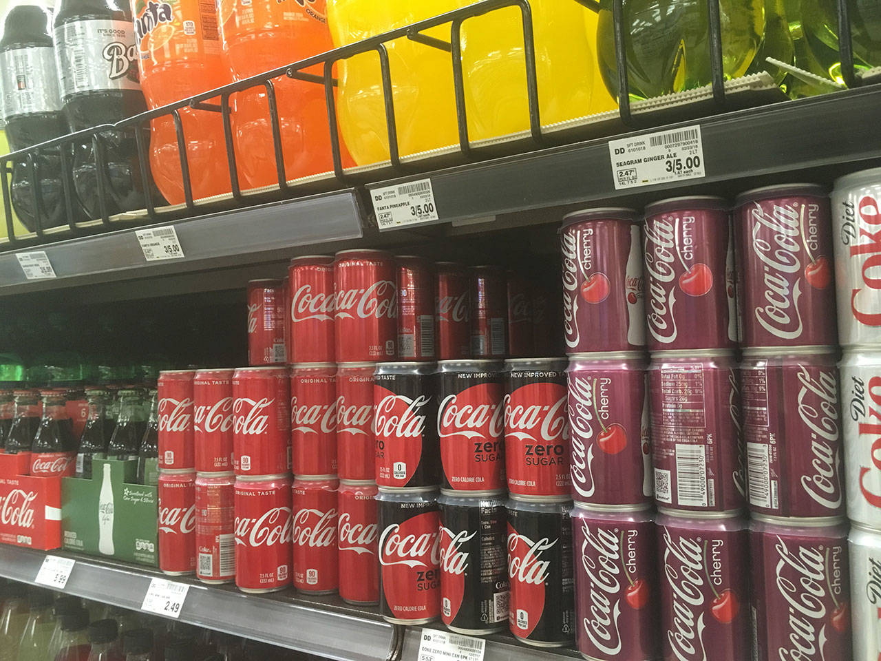 Pop and other sugary drinks became a bit more expensive in Seattle after a tax was placed on the products. The industry is getting ahead of future taxes by seeking a ban on them in the Washington State Legislature. (Sue Misao / The Herald)