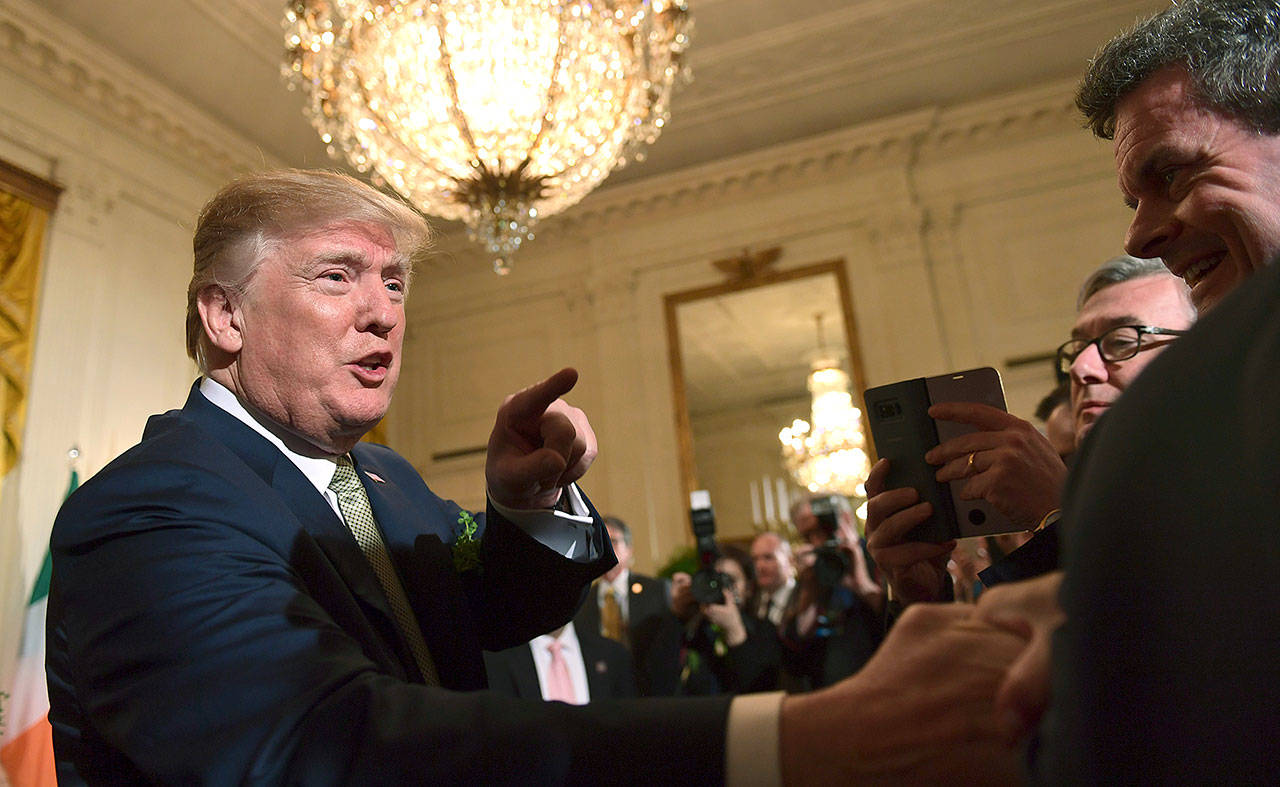President Donald Trump greets people during a St. Patrick’s Day reception in the East Room of the White House in Washington on Thursday. (AP Photo/Susan Walsh)